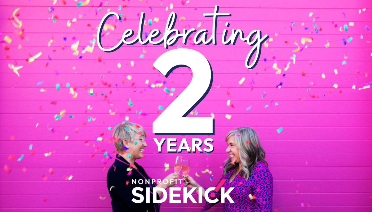 Wendy & Steph toast each other with chamapge as confetti falls from above. Text says Celebrating 2 Years